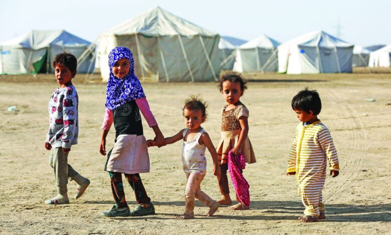 children walk at a camp for people recently displaced by fighting in yemen's northern province of al jawf between government forces and houthis, in marib