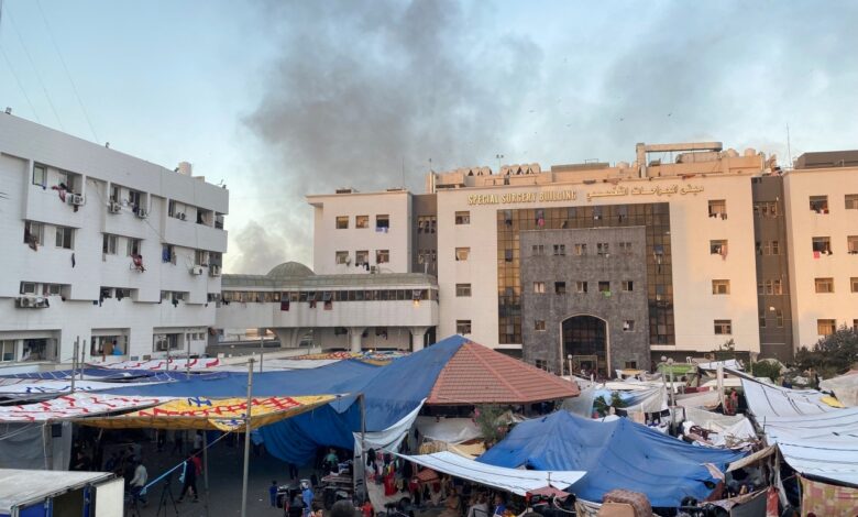 smoke rises as displaced palestinians take shelter at al shifa hospital, amid the ongoing conflict between hamas and israel, in gaza city